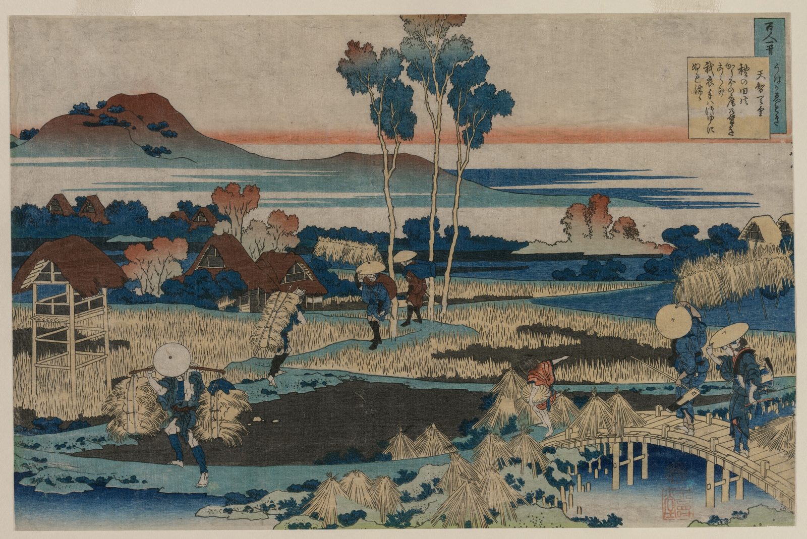 Autumn rice fields: farmers carry harvested sheaves on shoulder poles past drying stooks and thatched farmhouses as travelers cross a wooden bridge