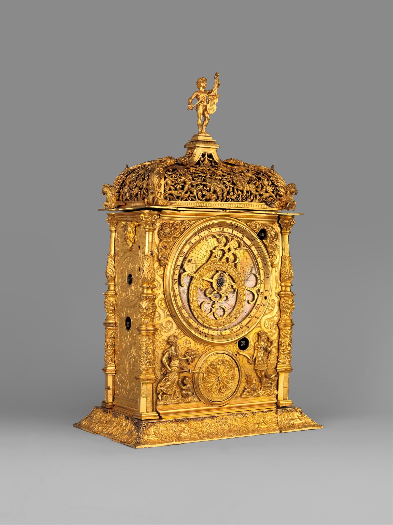 Gilded brass astronomical table clock, 1568, with a tiered pierced-work case, columns, a small figure on top and an astrolabe-style dial
