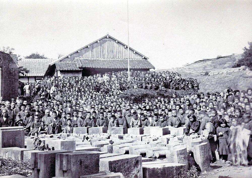 Villagers gathered for Sunday worship amid the wooden scaffolding around the unfinished brick walls of Urakami Cathedral, 1911.
